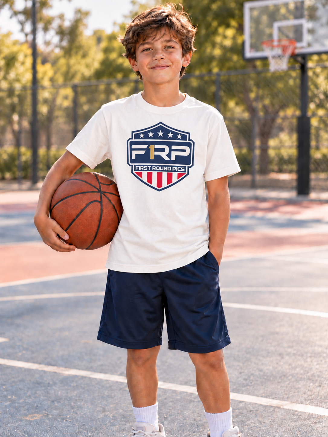 Approved fictional child in a basketball-court setting wearing the First Round Pics screen-print tee concept